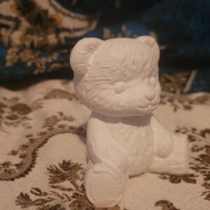 Close-up of one unpainted plaster teddy bear showing fur texture.