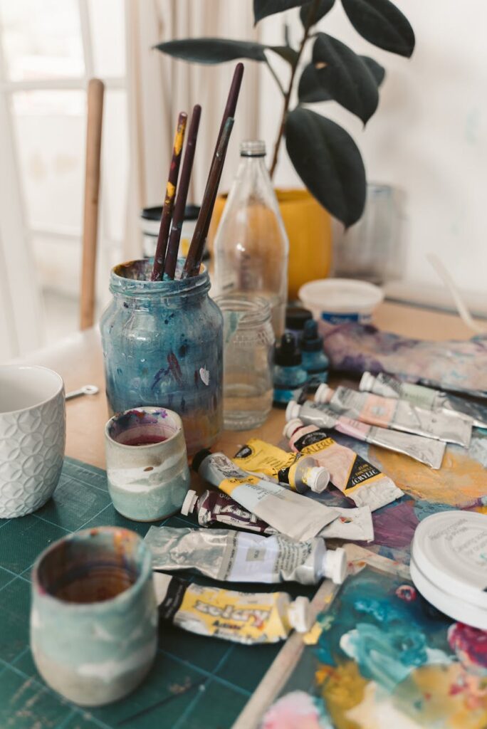 messy art materials on wooden table